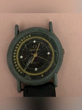 Omega Black Dial Watch with Gold Accents and Crystal Markers
